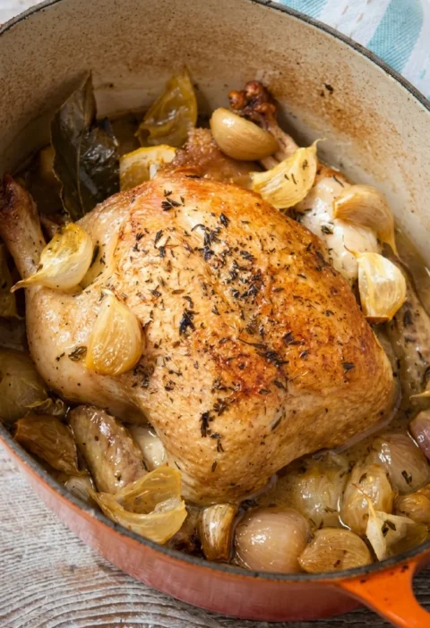 Hairy Bikers 40 cloves of garlic chicken, a whole browned chicken with soft garlic and shallots in a casserole