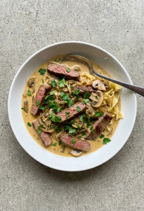 Beef stroganoff with seared fillet strips in a creamy mustard sauce with mushrooms and parsley