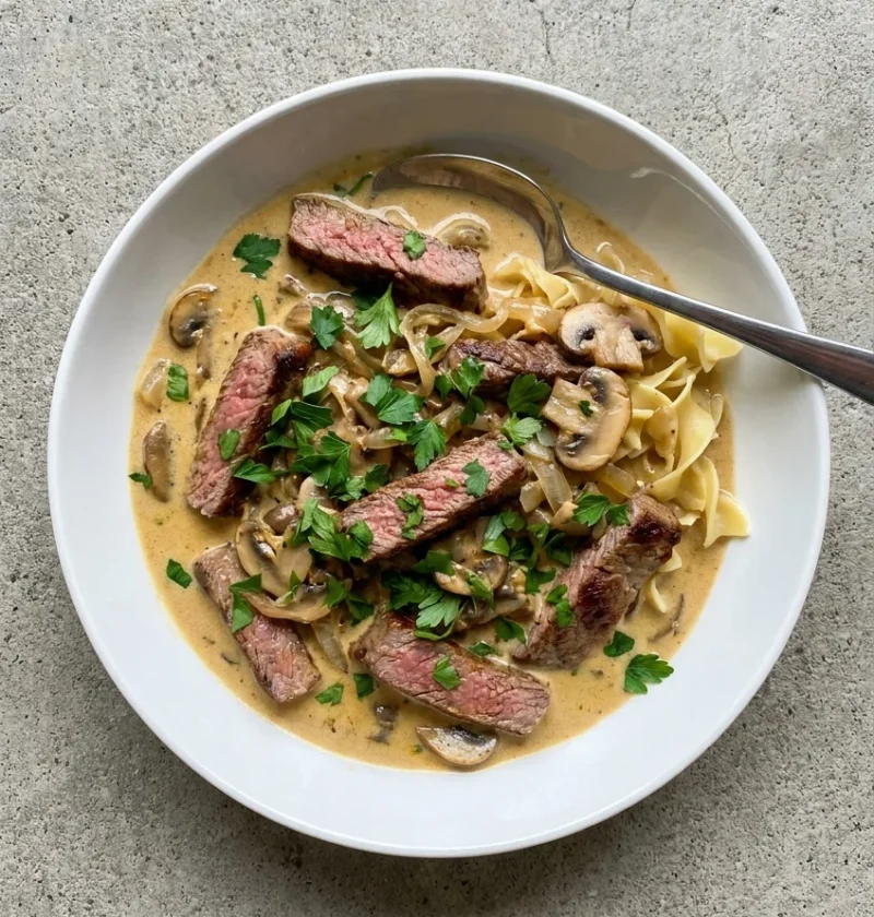 Beef stroganoff with seared fillet strips in a creamy mustard sauce with mushrooms and parsley