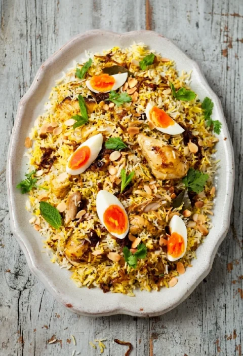 Hairy Bikers chicken biryani with saffron rice, eggs and toasted almonds on a platter