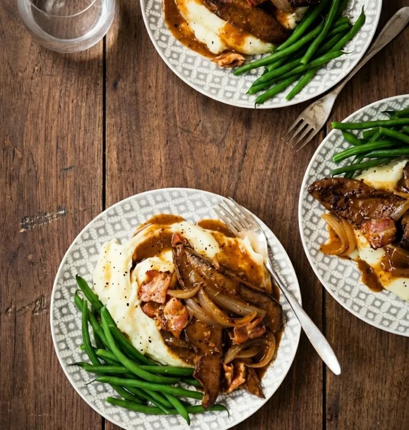 Hairy Bikers liver and bacon on patterned plates with onion gravy, mashed potato and green beans